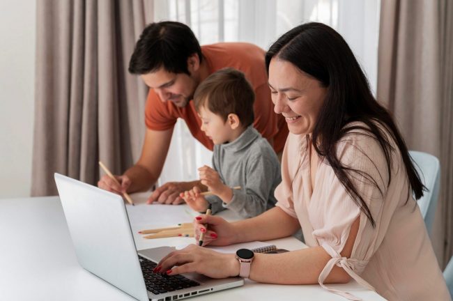 Photo of family with laptop illustrates blog: "Homeowners Insurance and Personal Injury Coverage: What You Need to Know"