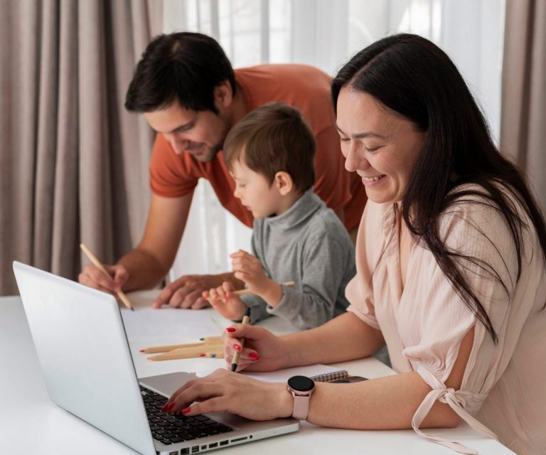 Photo of family with laptop illustrates blog: "Homeowners Insurance and Personal Injury Coverage: What You Need to Know"