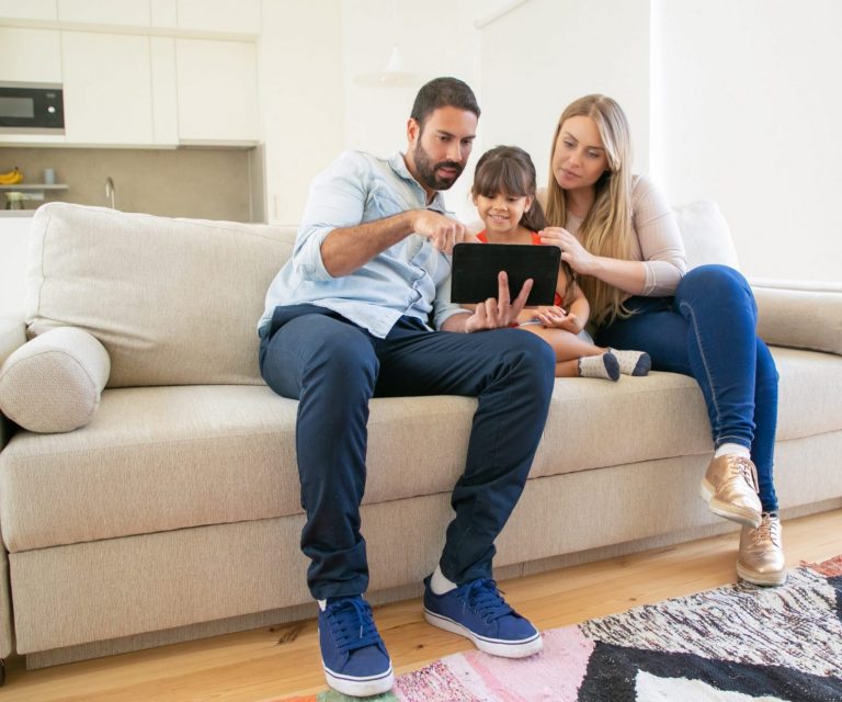 Photo of family in living room illustrates blog: "Homeowners Insurance: What Is Ordinance or Law Coverage?"