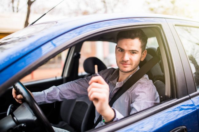 Man in car holding keys illustrates blog: "Non-Owner Car Insurance in California: What You Need to Know"