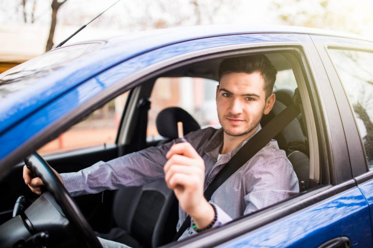 Man in car holding keys illustrates blog: "Non-Owner Car Insurance in California: What You Need to Know"