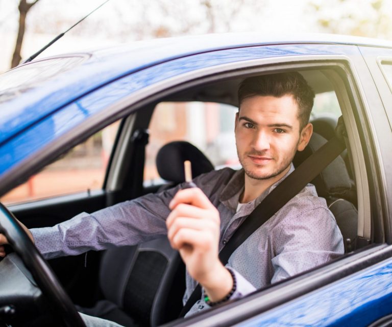 Man in car holding keys illustrates blog: "Non-Owner Car Insurance in California: What You Need to Know"