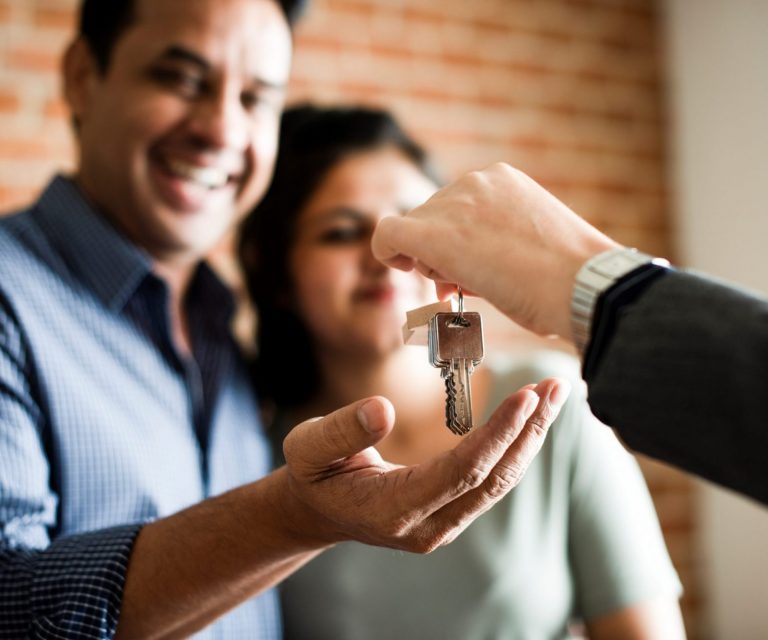 Photo of couple receiving keys illustrates blog: "How Does Renters Insurance Work?"