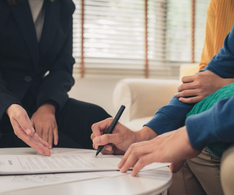 Photo of couple signing documents illustrates blog: "Earthquake Insurance In California: 4 Facts You Need to Know"