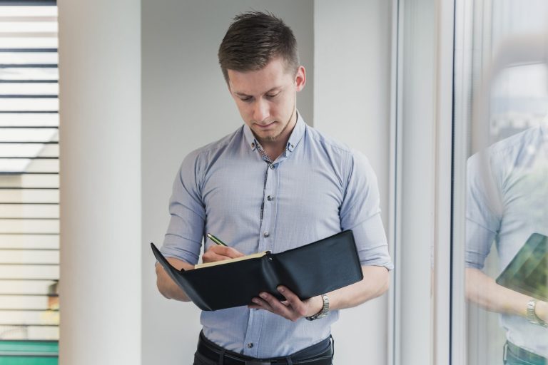 documents-fp Man looking at folder illustrates blog "Does Collision Insurance Cover a Hit-and-Run?"