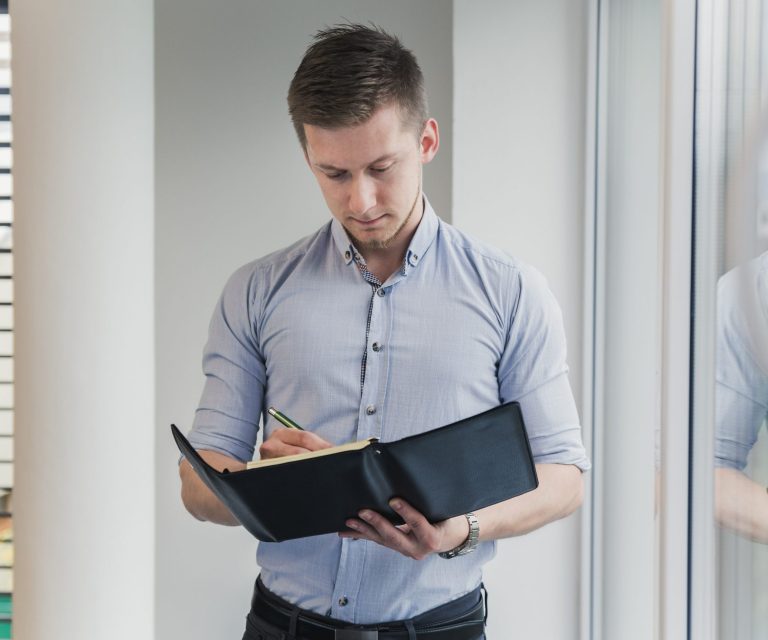 documents-fp Man looking at folder illustrates blog "Does Collision Insurance Cover a Hit-and-Run?"