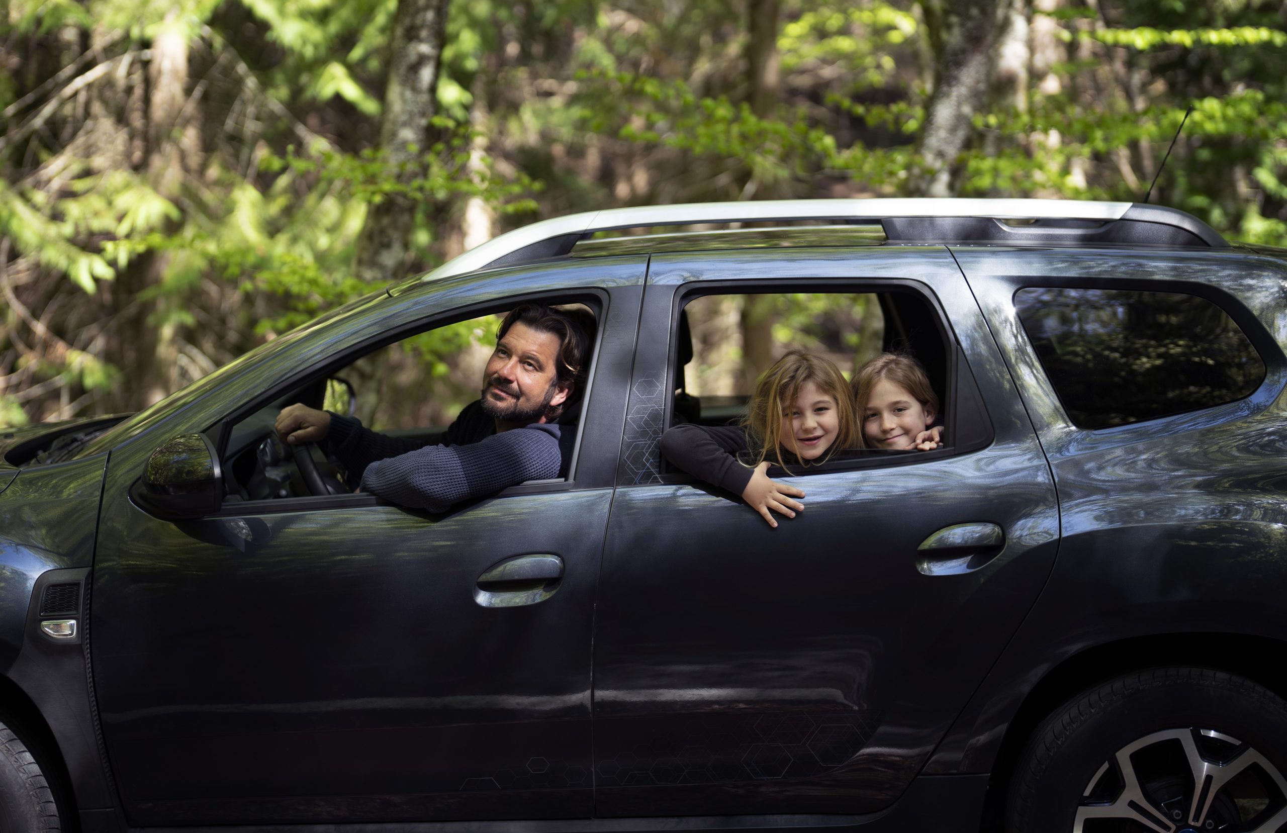 family-car-fp Man at the wheel of SUV with two kids in the backseat illustrates blog "Car Insurance vs Car Warranty: What Is the Difference?"