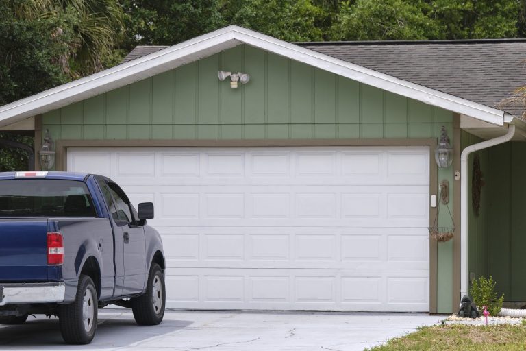 Photo of garage with pickup truck in the driveway