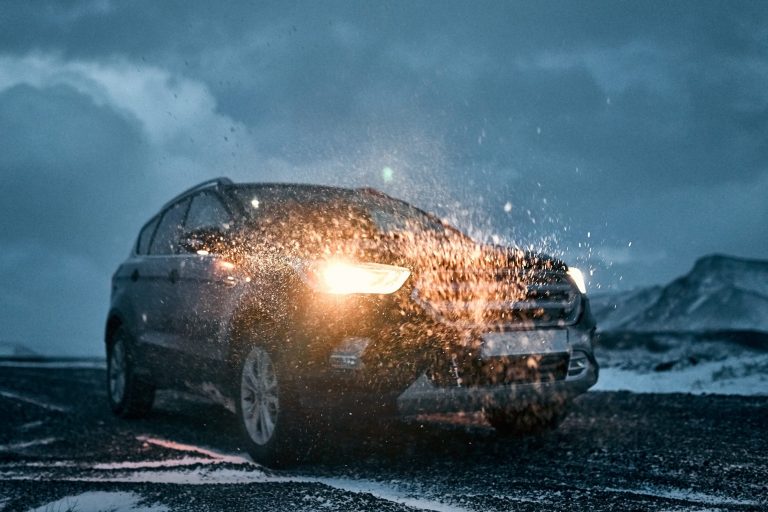 Car in the rain illustrates blog "Does Your Auto Insurance Cover Flood Damage?"