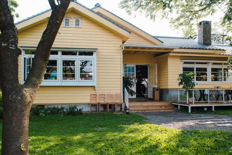 Yellow home with green lawn