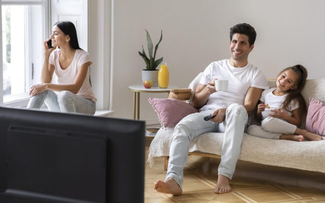 hvac-insurance Mom, dad, and daughter sitting in living room illustrates blog "Will Home Insurance Cover a Broken HVAC?"