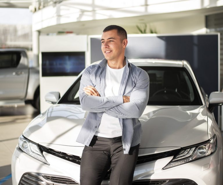 Man leaning against car illustrates blog "Auto Insurance: Is California a No-Fault State?"