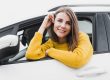 Woman smiling in car illustrates blog "Is Auto Insurance Property or Casualty?"